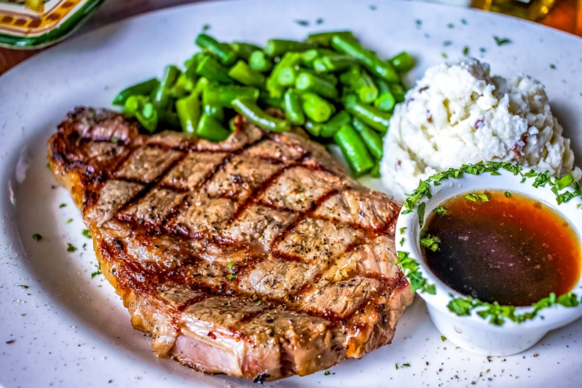 Steak dish with sides and sauce